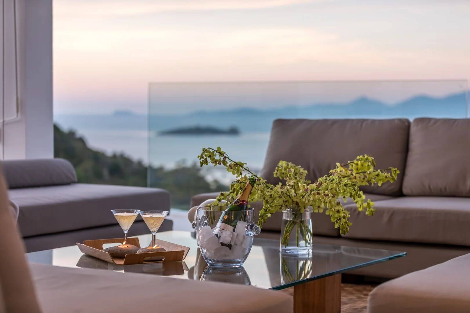 Champagne on ice and two coupes on the lounge table at last light.