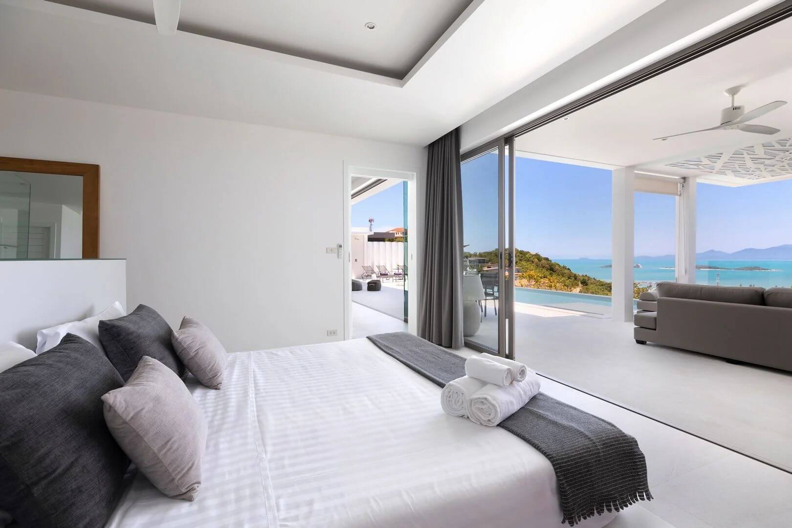 Suite four — the bed facing the terrace, the sala and the open water.